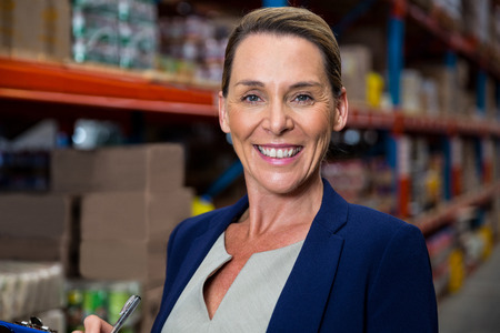 Business woman posing for the camera in a warehouseの写真素材
