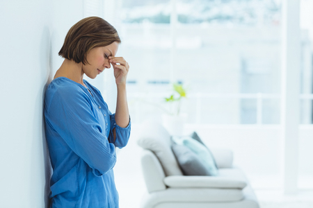 Side view of sad woman standing at homeの写真素材