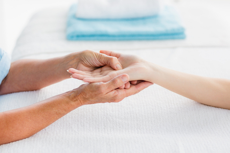 Cropped image of woman receiving hand massage at spaの写真素材