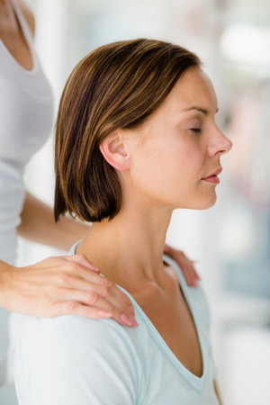 Cropped image of masseur giving massage to woman at spaの写真素材
