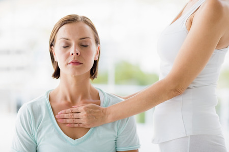 Young woman receiving masaage from masseurの写真素材