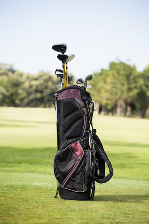 Filled golf bag with golf club on the fieldの写真素材