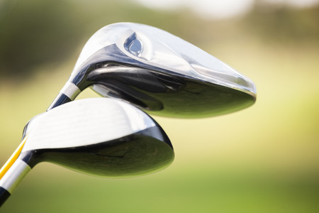 Focus on foreground of golf club on fieldの写真素材