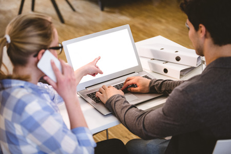 Rear view of young executives working at creative officeの写真素材