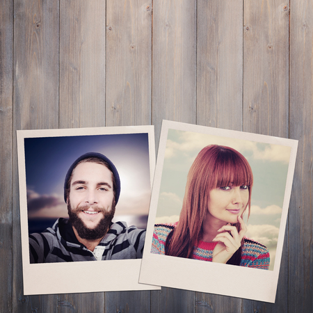 Portrait of a smiling hipster woman against pale grey wooden planksの写真素材