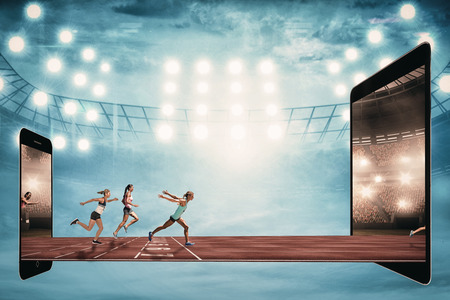 Sportswoman finishing her run against view of a running trackの写真素材