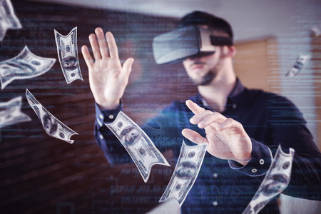 Dollars flying against man wearing virtual glassの写真素材