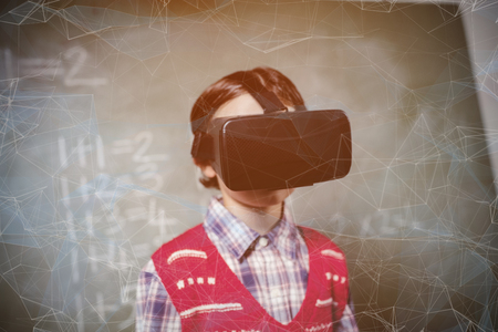 Black background with shades against boy using a virtual reality deviceの写真素材
