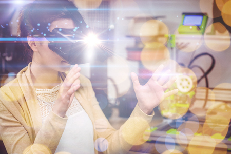 Black background with spark against female graphic designer using the virtual reality headset