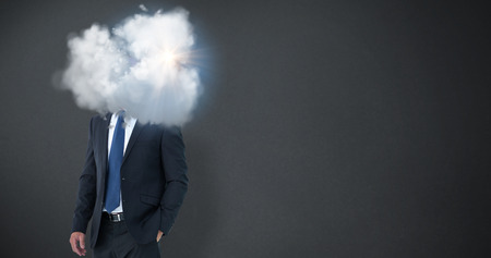 Happy businessman against grey backgroundの写真素材