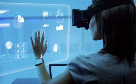 Abstract technology interface against businesswoman standing while using a virtual glasses