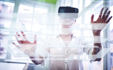 Business interface against woman using a virtual reality deviceの写真素材