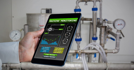 Man using tablet pc  against workshopの写真素材