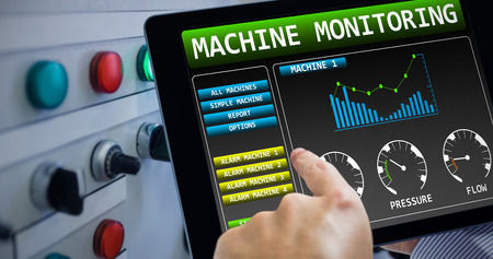 Man using tablet pc  against hand pressing on green button of the machine