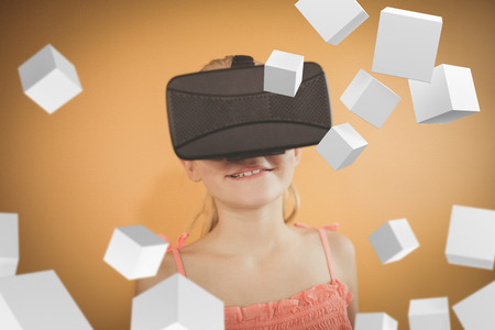 Digitally generated grey cubes floating  against girl using the virtual reality deviceの写真素材