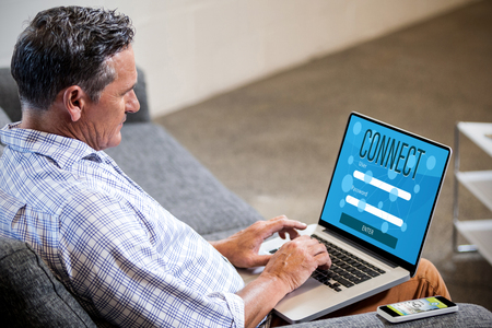 Smartphone apps icons against profile view of a businessman working on computerの写真素材