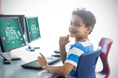 back to school against smiling boy using computer