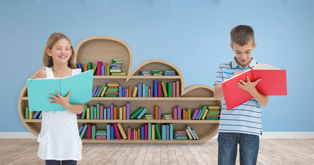 Brother and sister doing their homework together against room with wooden floorの写真素材