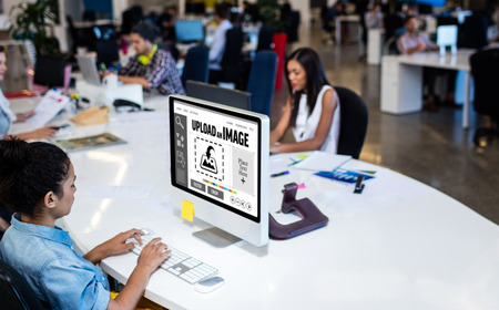 Designer interface against people working at officeの写真素材