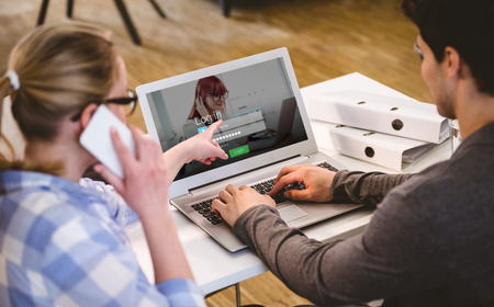 Login screen with redheaded woman and laptop against rear view of executives working at creative officeの写真素材