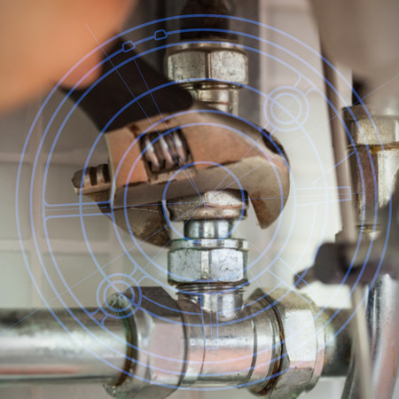 Blueprint against close up of hand repairing pipes