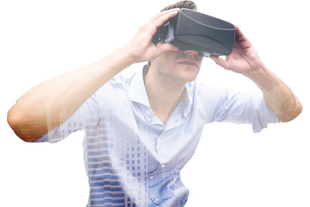 Man using a virtual reality device against aerial view of a city on a cloudy day