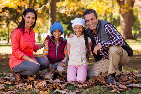 Portrait of happy family at park during autumn