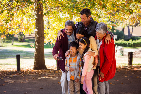 Happy multi-generation family taking selfie at parkの写真素材