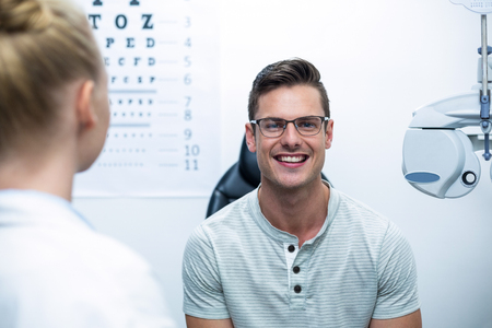 Portrait of smiling patient in ophthalmology clinicの写真素材