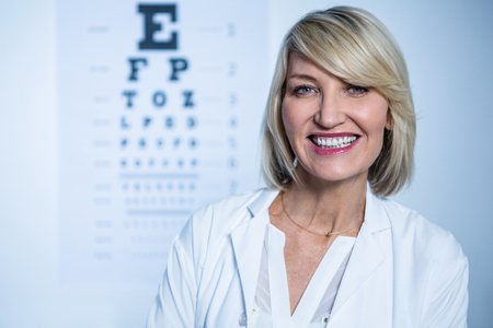 Portrait of smiling female optometrist in ophthalmology clinicの写真素材