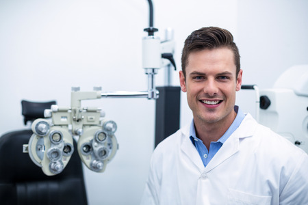 Portrait of smiling optometrist in ophthalmology clinicの写真素材