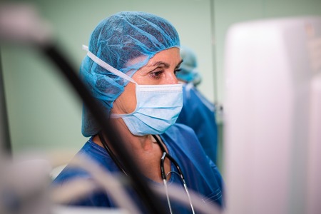 Surgeon using monitor in hospital roomの写真素材