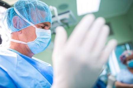Surgeon preparing for operation in operation room at the hospitalの写真素材