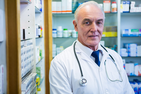 Portrait of pharmacist with a stethoscope in pharmacyの写真素材