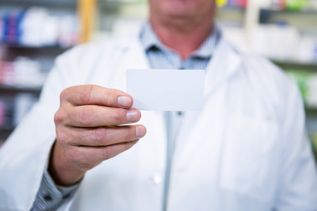 Pharmacist holding a prescription in pharmacyの写真素材