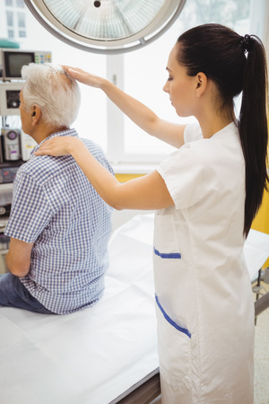 Female doctor examining a patient at the hospitalの写真素材