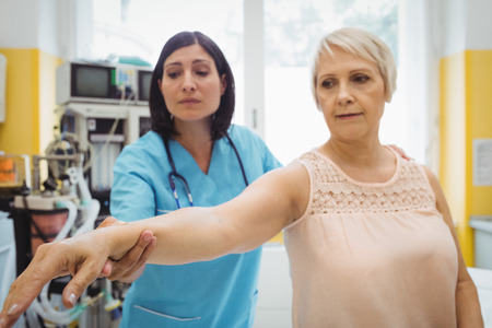 Female doctor examining a patient at the hospitalの写真素材