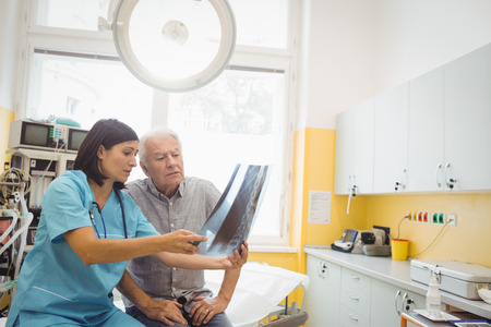 Female doctor discussing x-ray with patient at the hospital