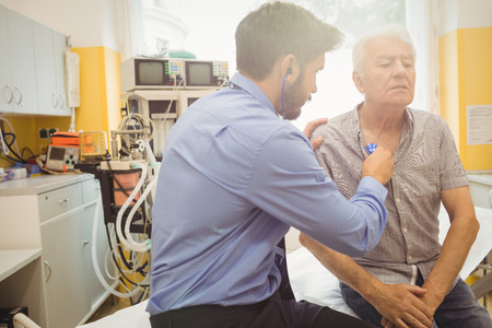 Male doctor examining a patient at the hospital