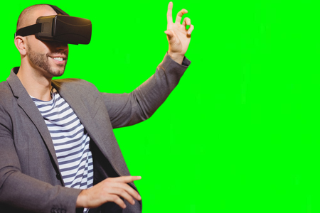 Man with virtual reality simulator against green vignette