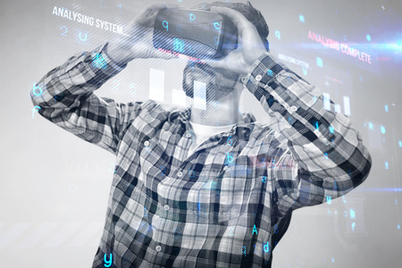 Man using an virtual glasses against blue backgroundの写真素材