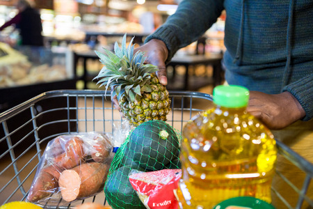 Man buying goods in grocery section at supermarket