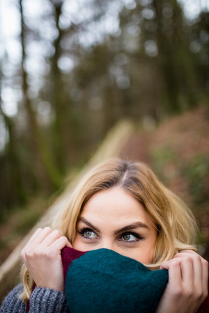 Close-up of beautiful smiling woman in forest