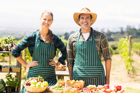 Portrait of smiling farmer couple at local marketの写真素材