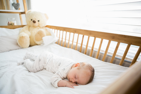 Baby boy sleeping on a cradle at homeの写真素材