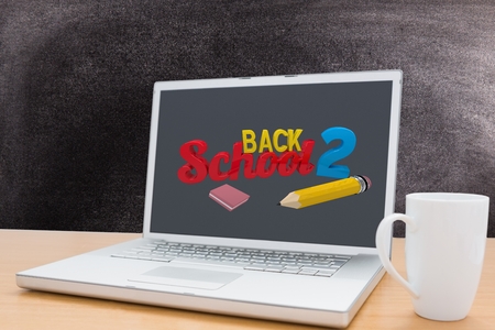 digital composite of laptop with back to school text and coffee mug with chalkboard backgroundの写真素材