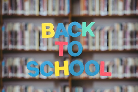 Digital composite of Back to school text with library backgroundの写真素材