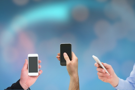 digital composite of hands holding smartphones