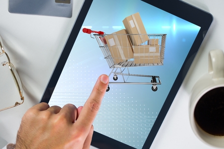 Composite image of hand touching a screen of tablet computer for e commerce