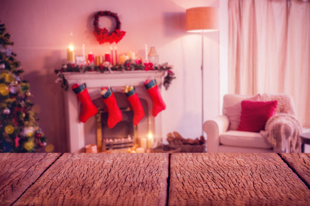 Wooden floor  against fireplace decorate with christmas decor and ornamentsの写真素材
